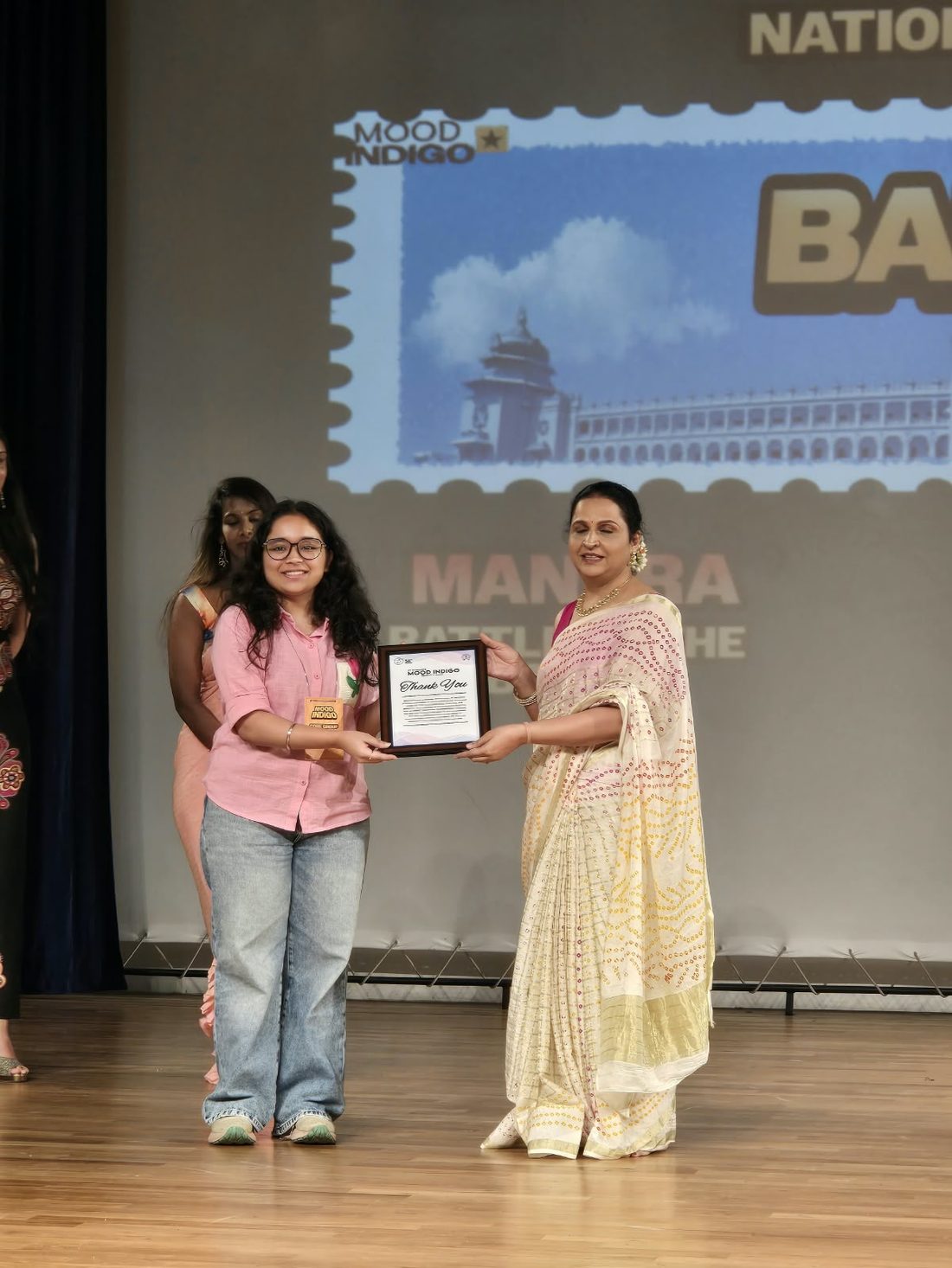 Shalu presenting a certificate at a dance event