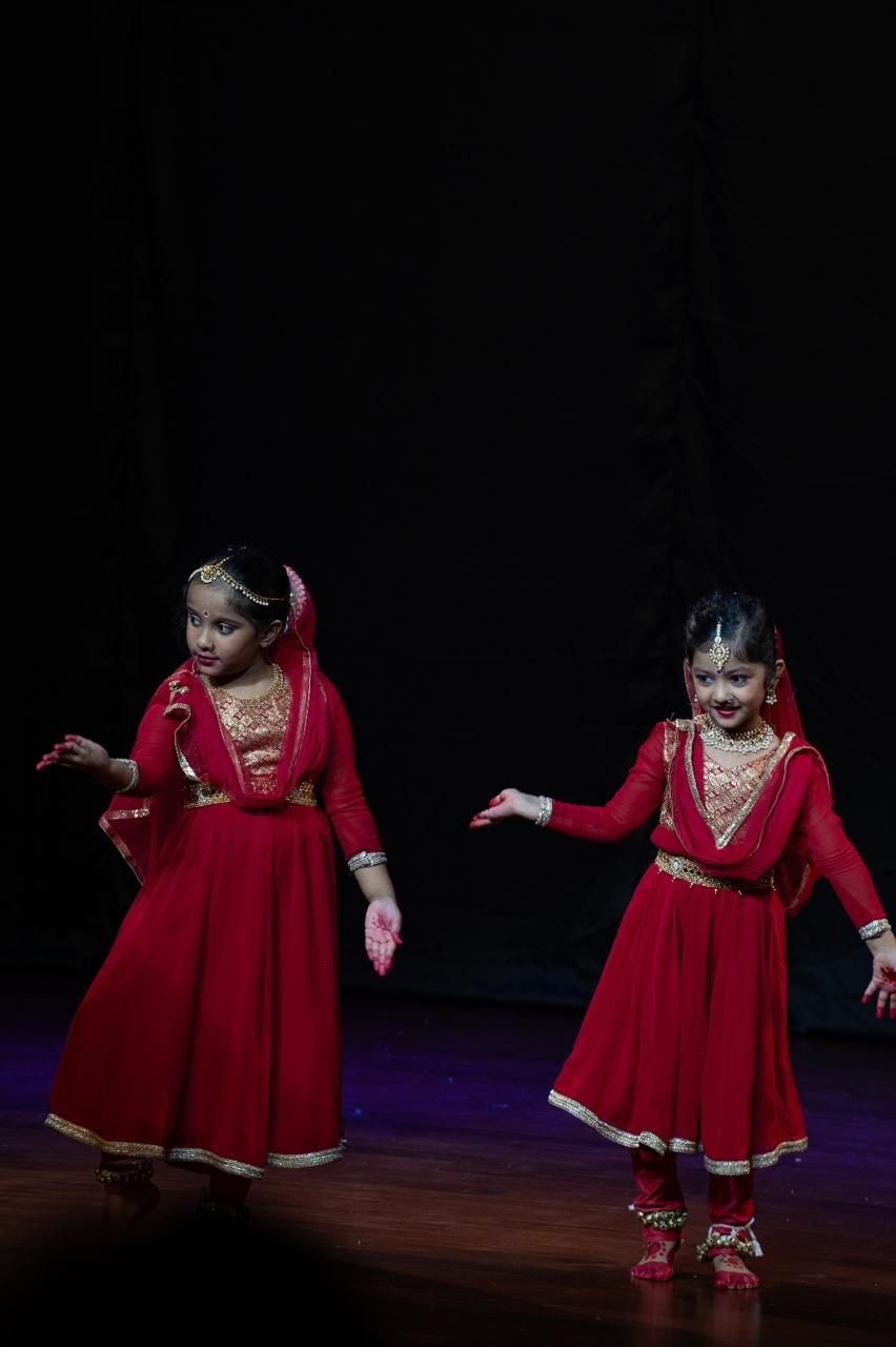 Young Kathak students performing on stage