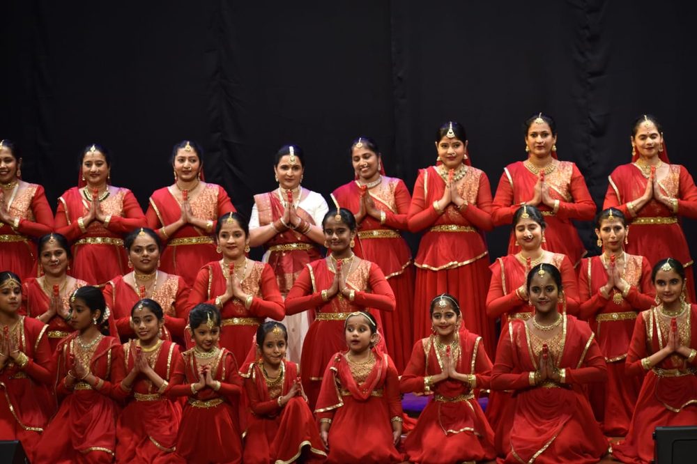 NrityaShrm Kathak ensemble in red costumes