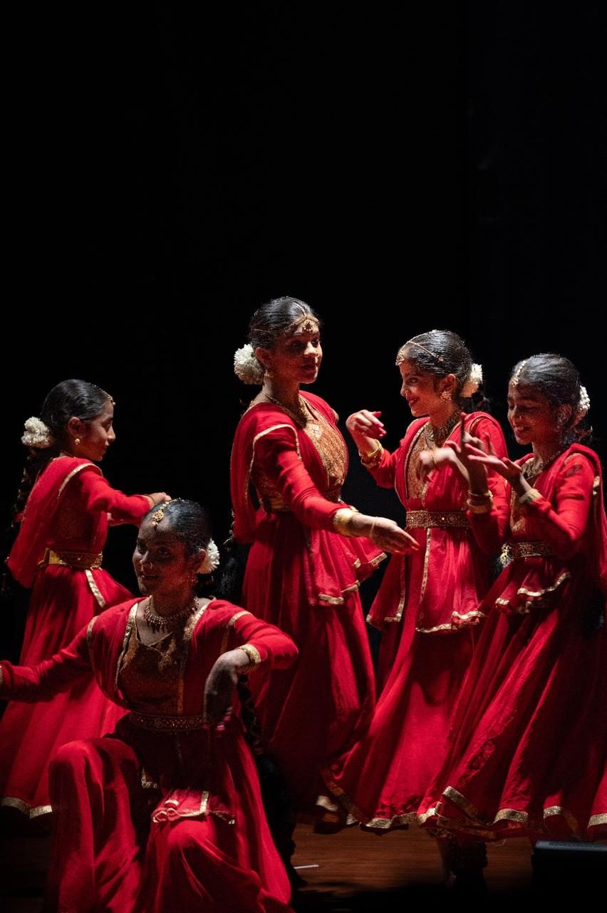 NrityaShrm students in red costumes on stage