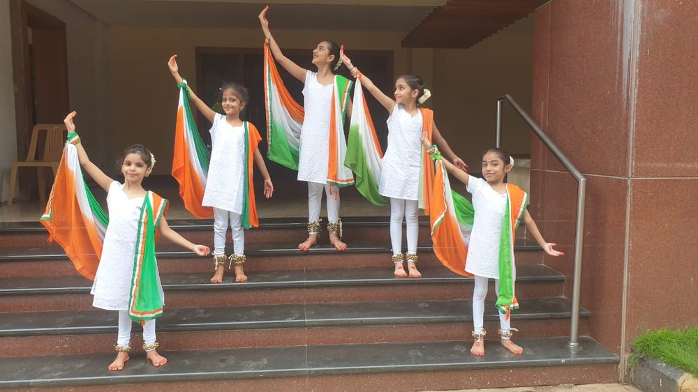 Young NrityaShrm students performing with the tricolour